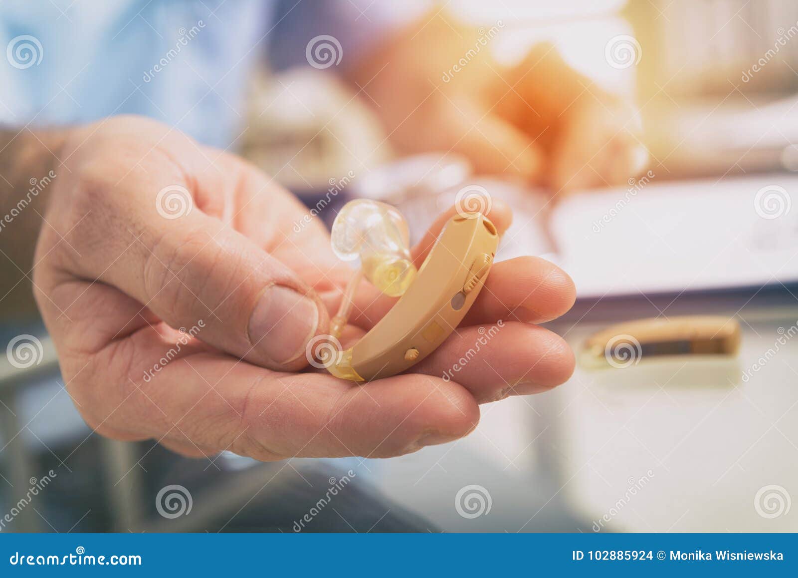 doctor holding hearing aid