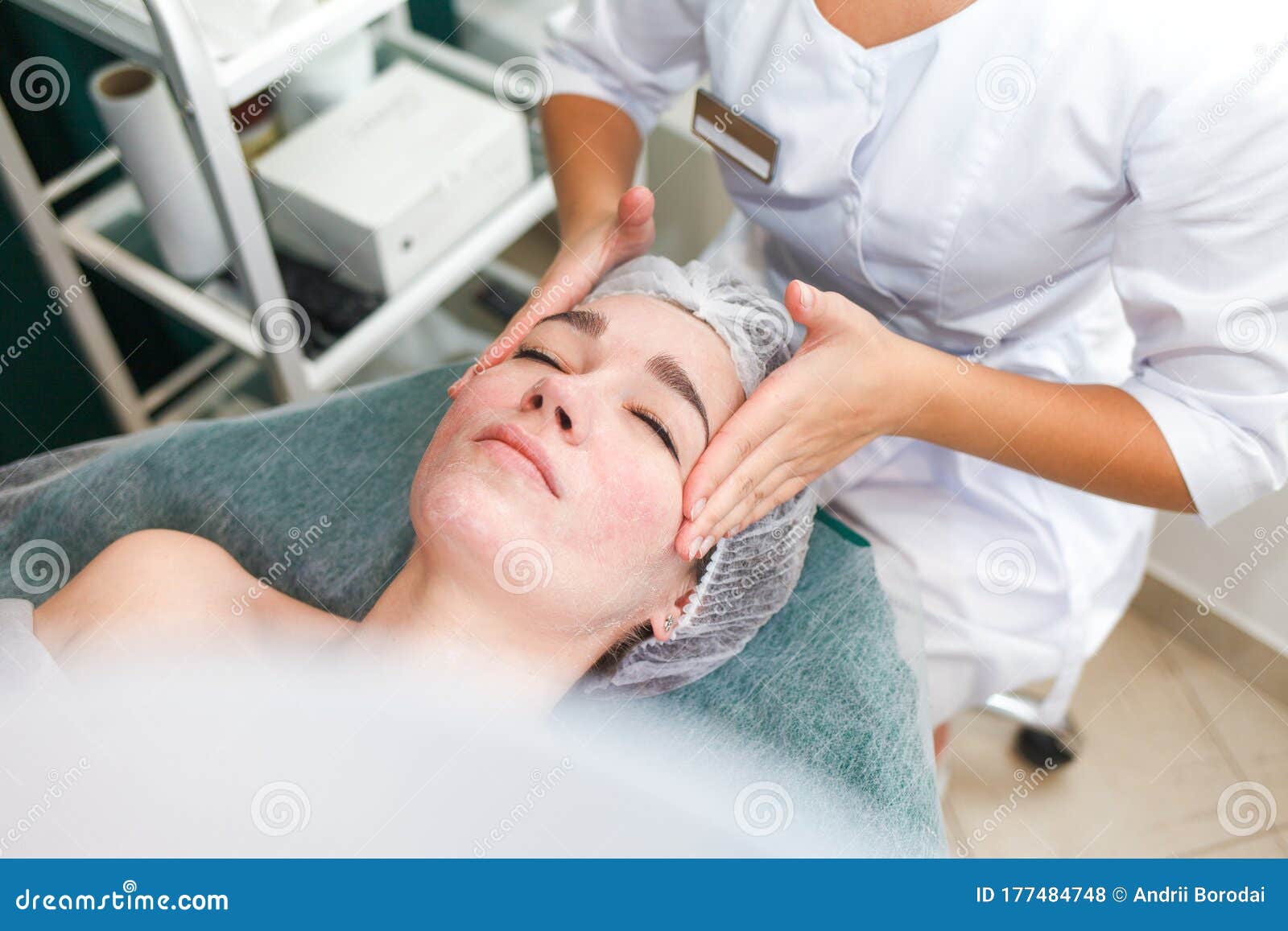 Doctor Beautician Makes Cosmetic Facial Massage Woman Relaxes On A Cosmetic Chair Side View