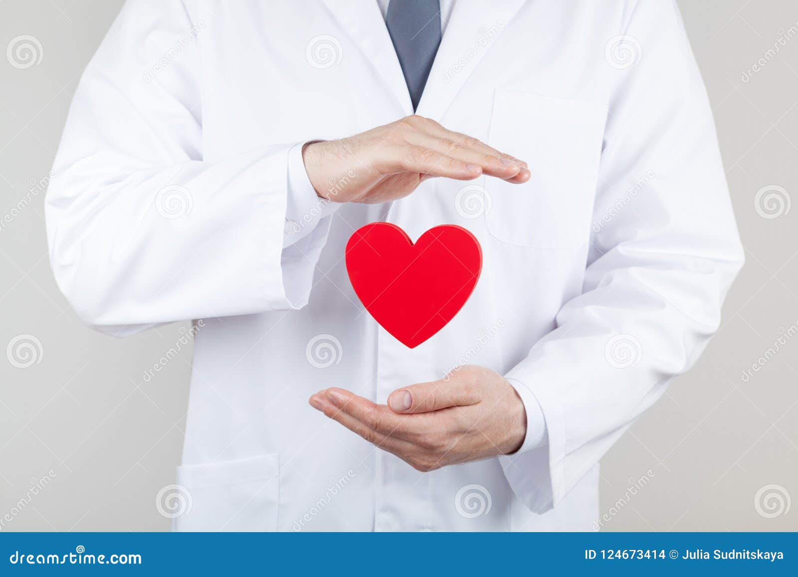 doctor cardiologist hands with flying heart. cardiology and heart disease concept.