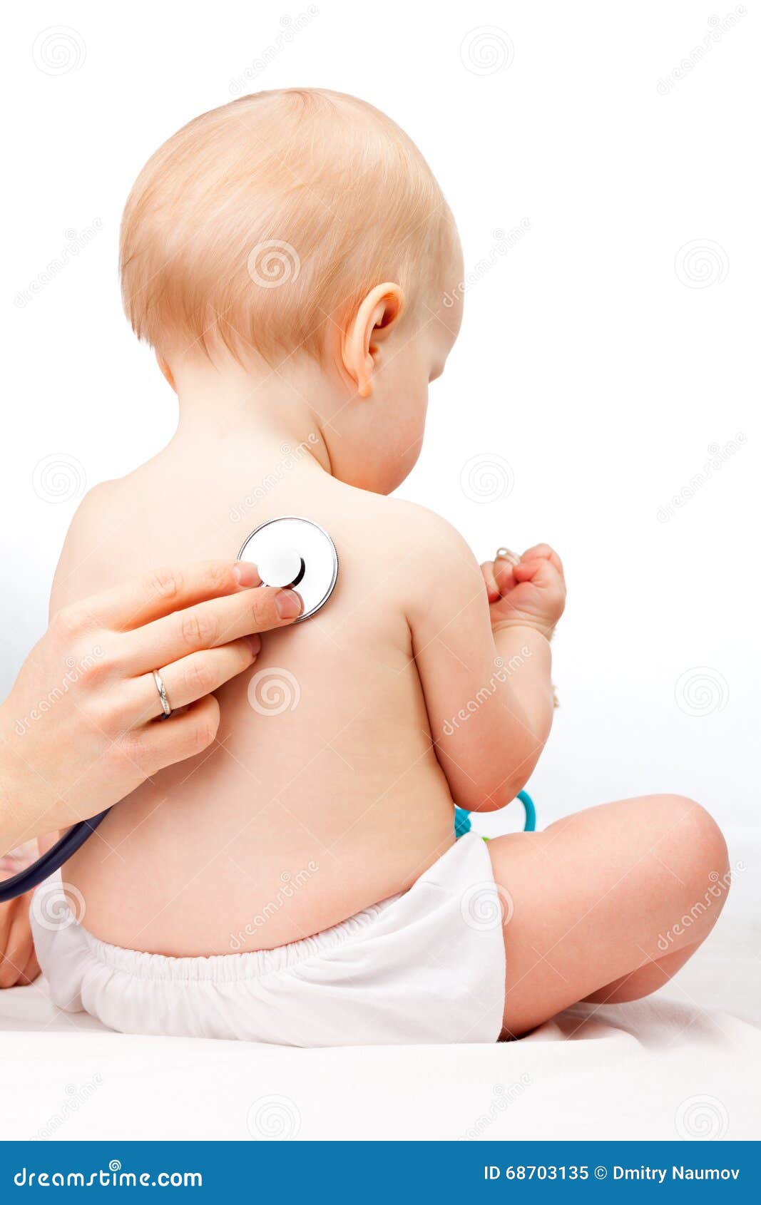 Doctor checking infant heart beat with stethoscope. Pediatrician examines little baby girl using a stethoscope to listen to baby s back checking heart beat