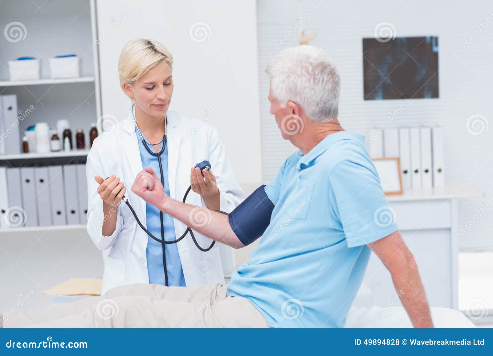 doctor checking senior mans blood pressure