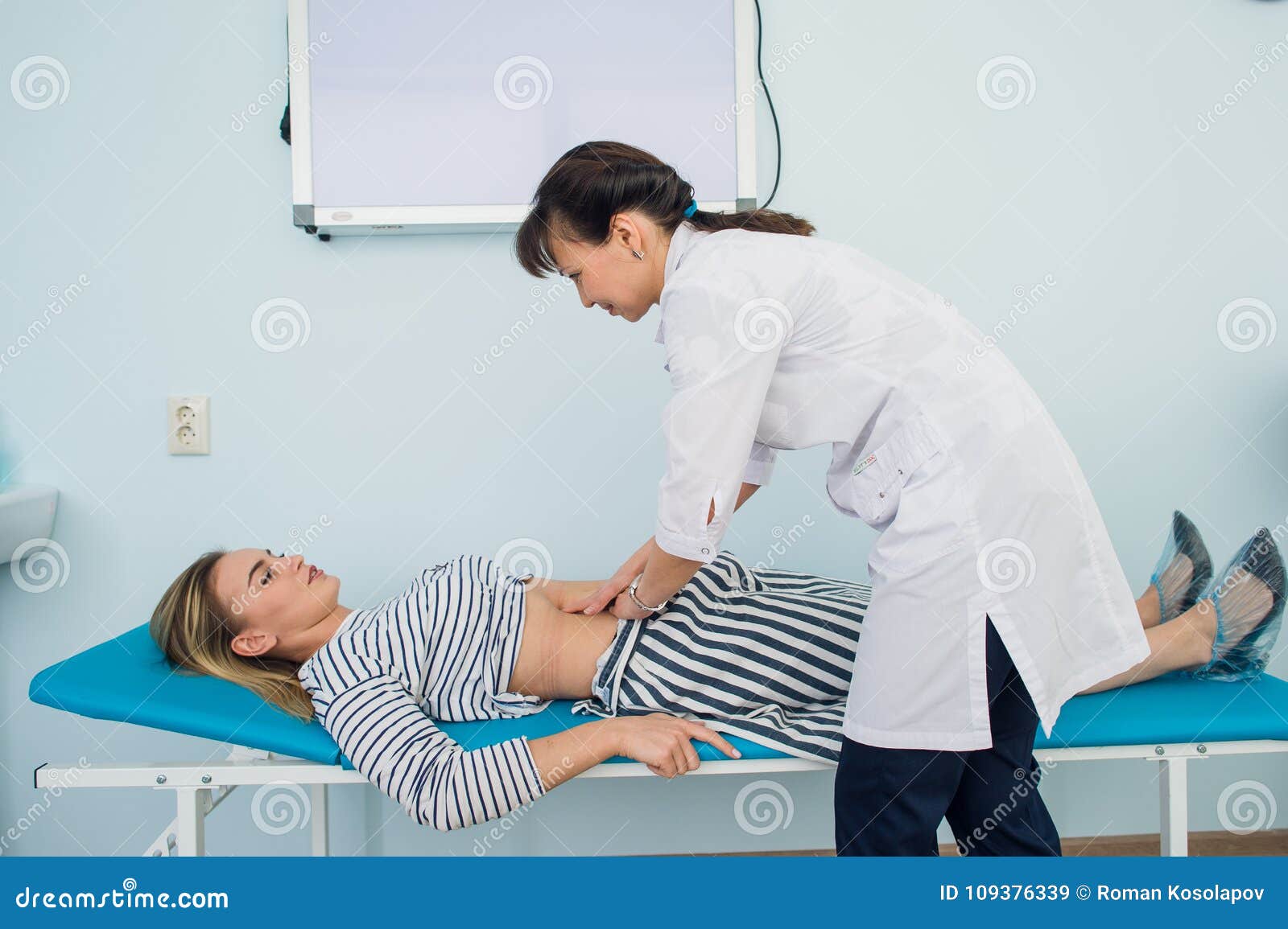 Doctor Checking the Stomach of One of Her Patients Stock Image Image