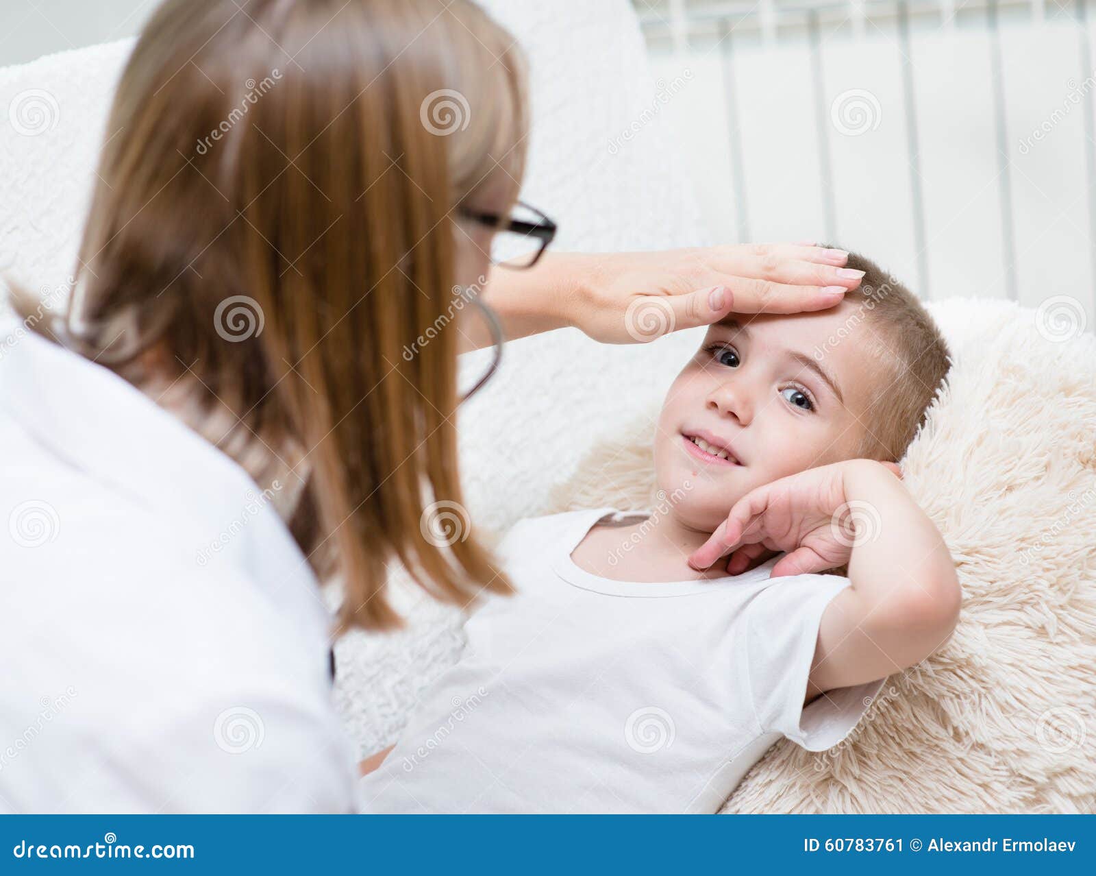 Doctor Checks The Temperature Of A Boy Touching His Forehead Stock