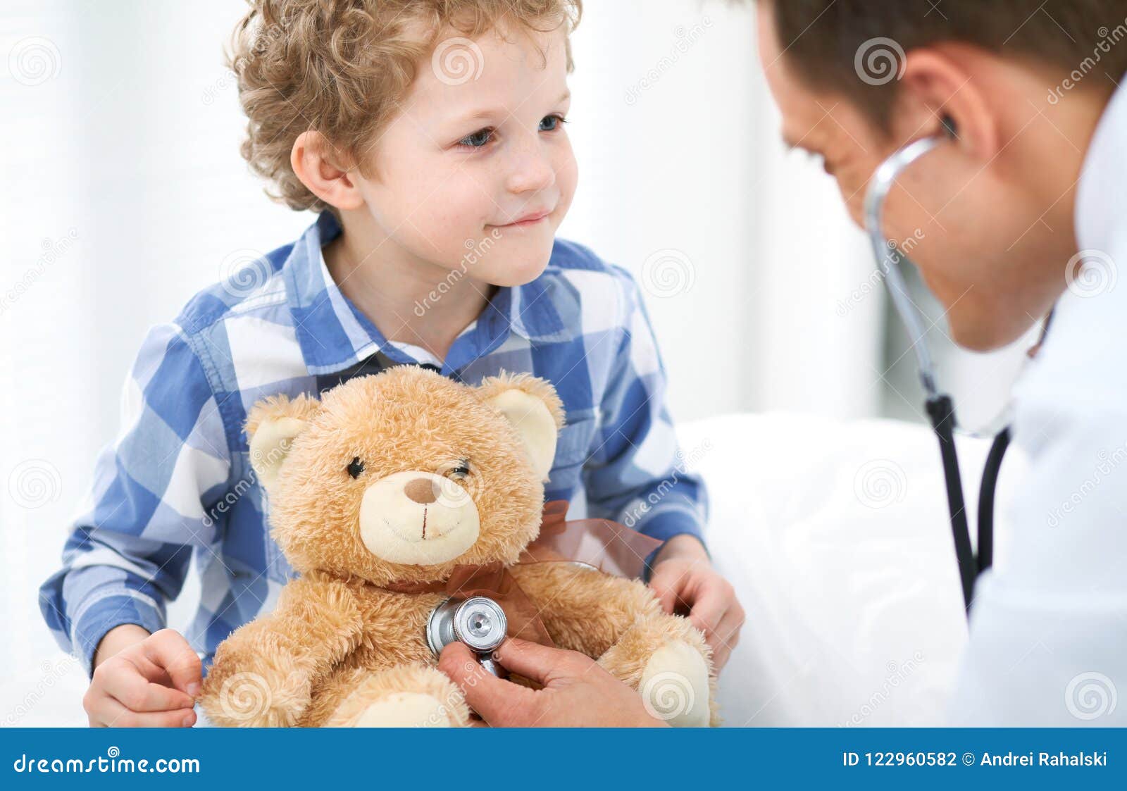 doctor and child patient. physician examines little boy by stethoscope. medicine and children`s therapy concept