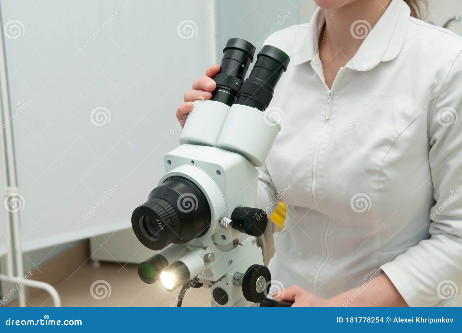 doctor with colposcope in gynecology room