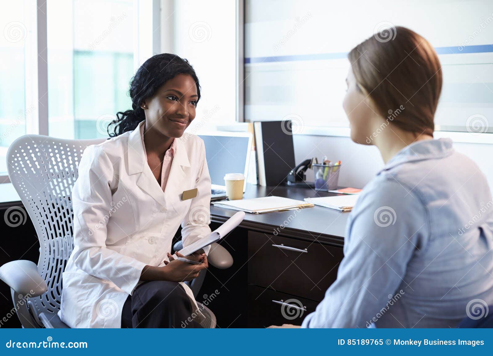 doctor in consultation with female patient in office