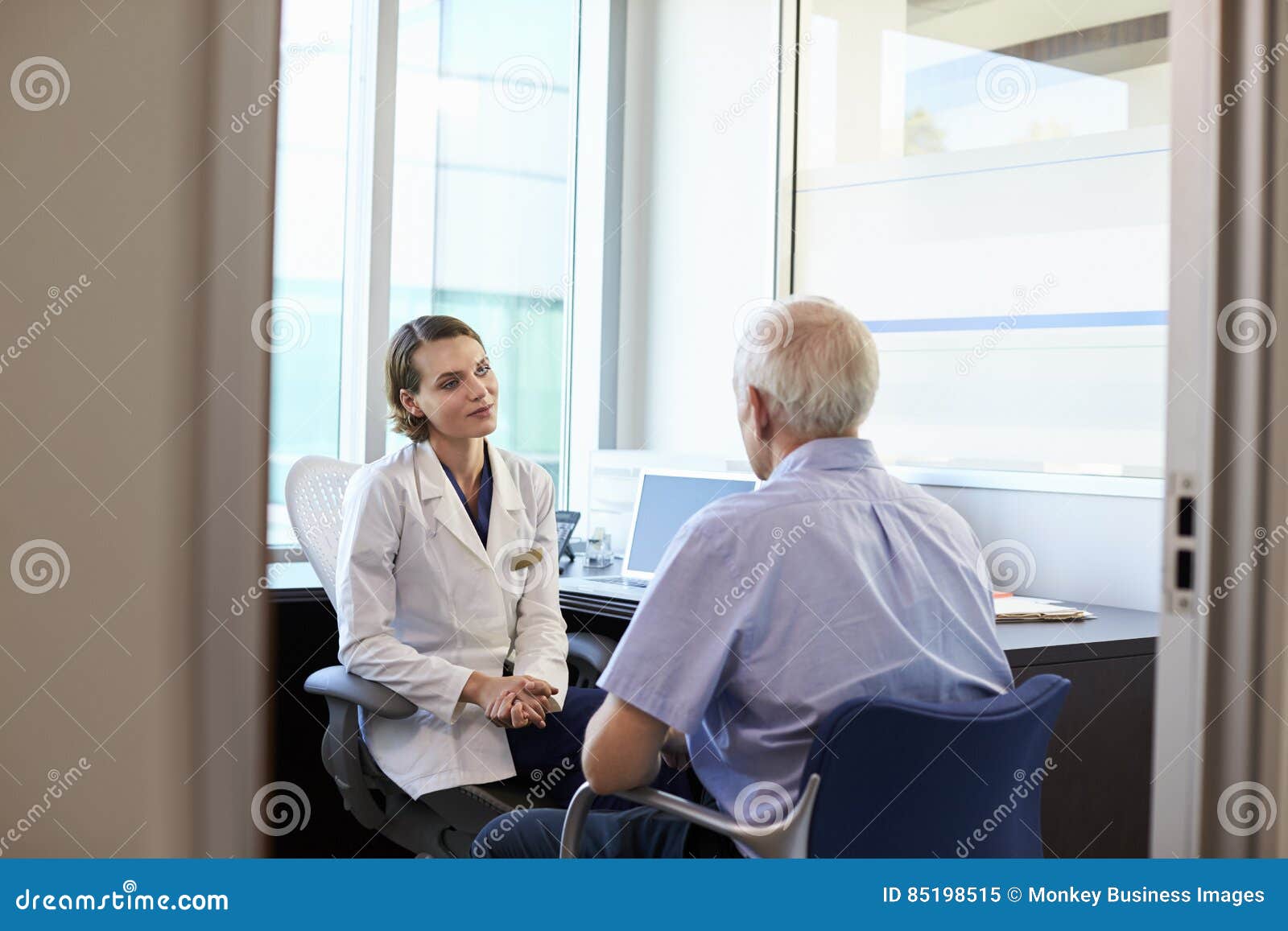 doctor in consultation with male patient in office
