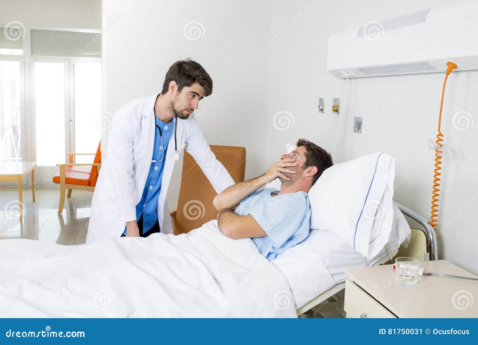 doctor consulting patient lying on hospital bed talking worried giving bad news about the diagnose