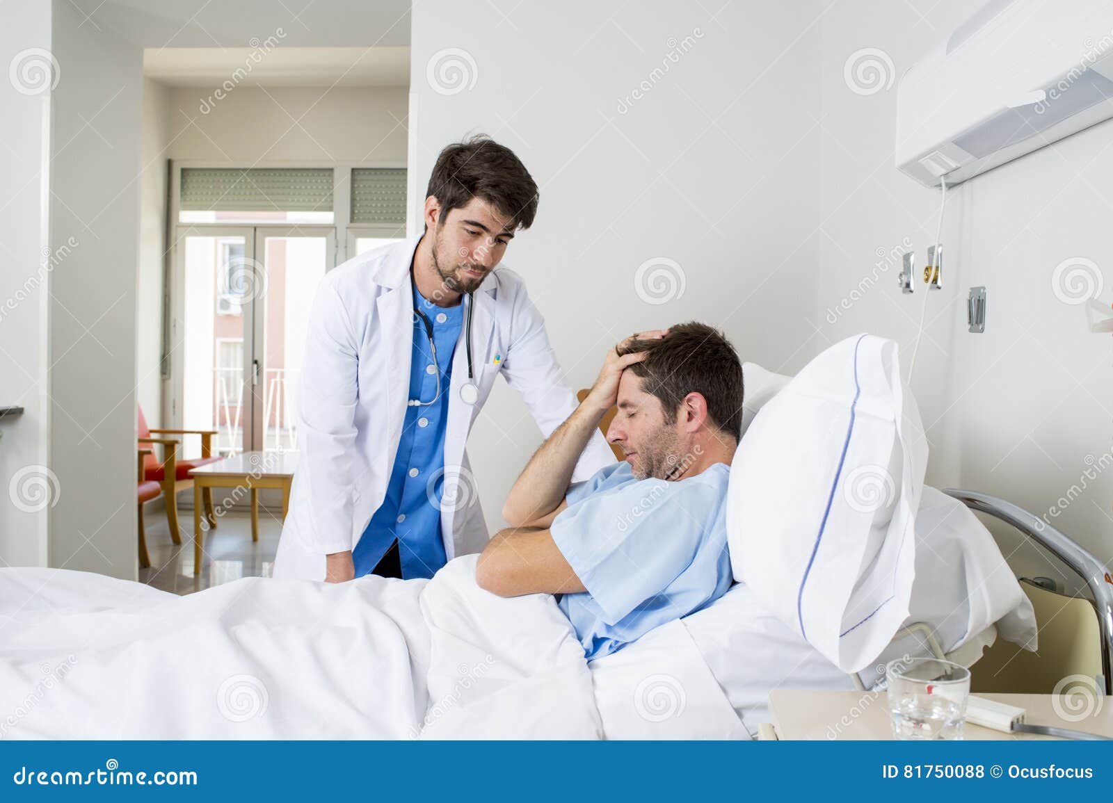 doctor consulting patient lying on hospital bed talking worried giving bad news about the diagnose