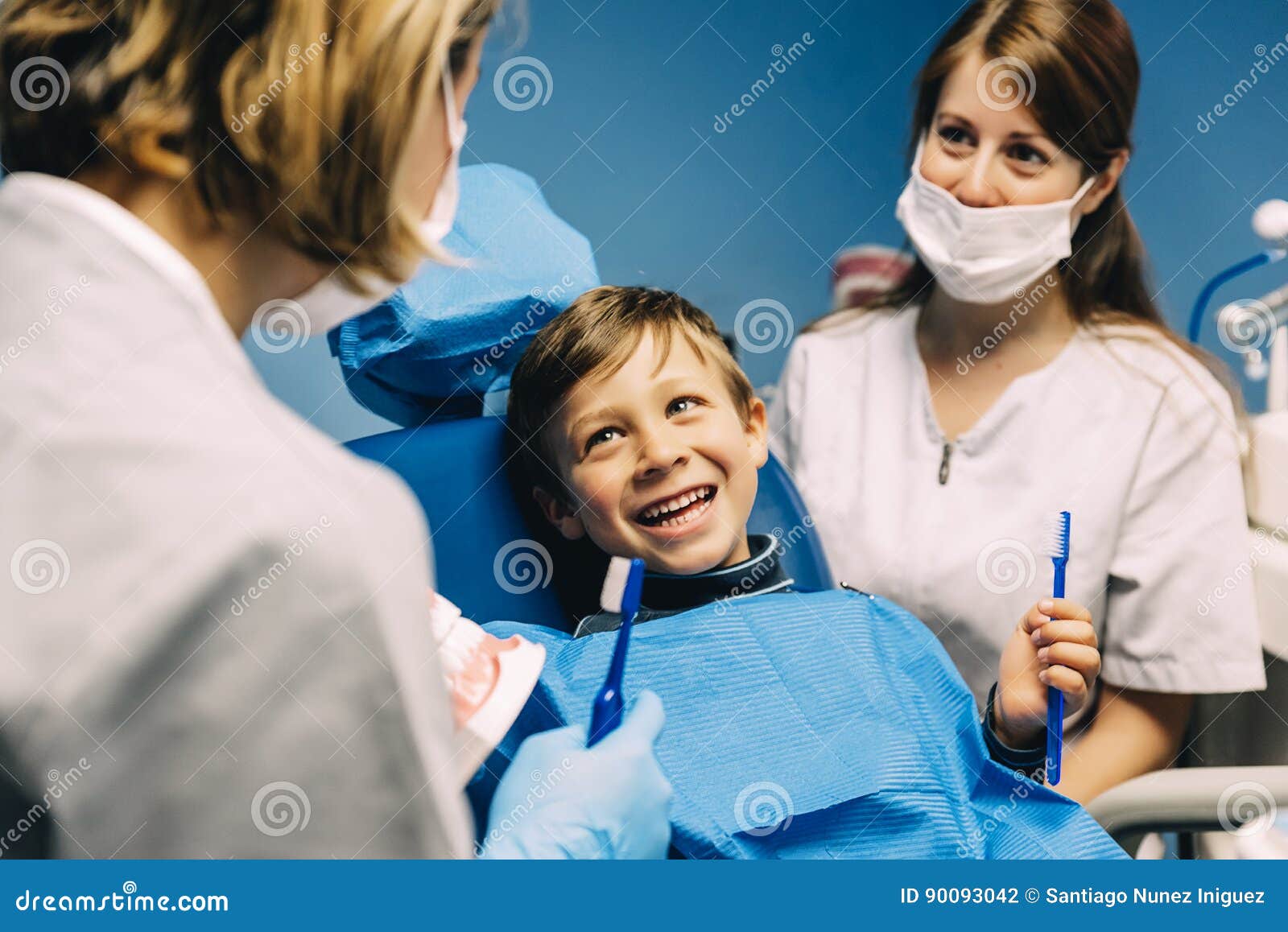 Doctor Dentist Teaching A Child To Brush Teeth. Stock