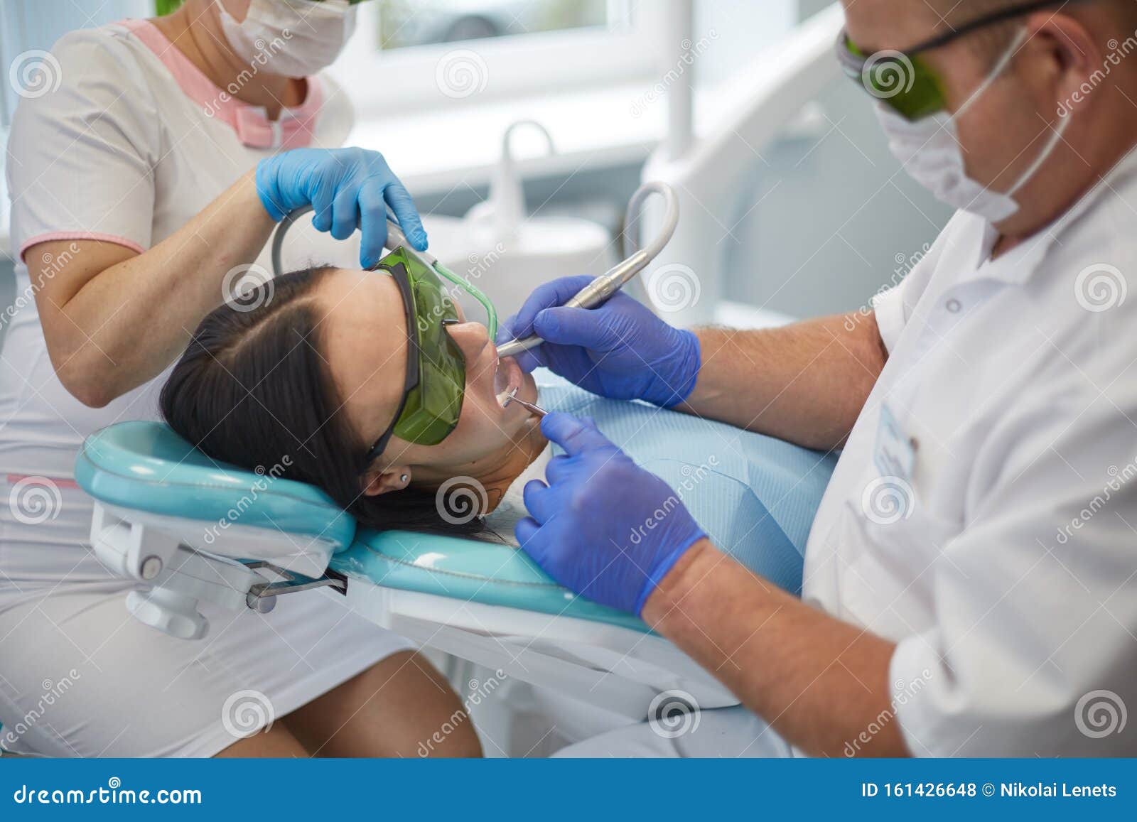 Doctor Dentist Treats Teeth Of A Beautiful Young Girl Patient The Girl