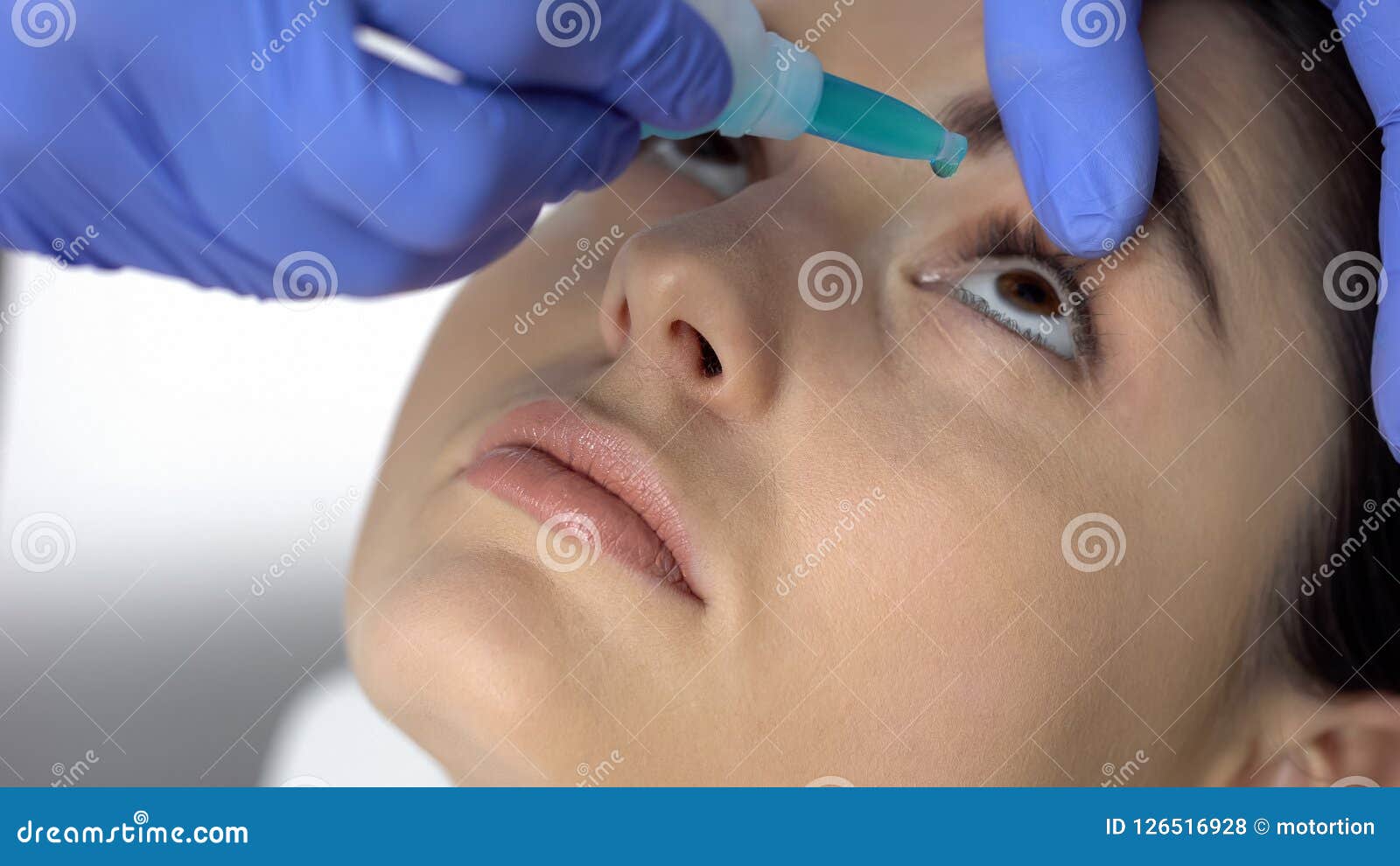 doctor dripping medicine into patient eyes, eyesight checkup, dryness of eyeball