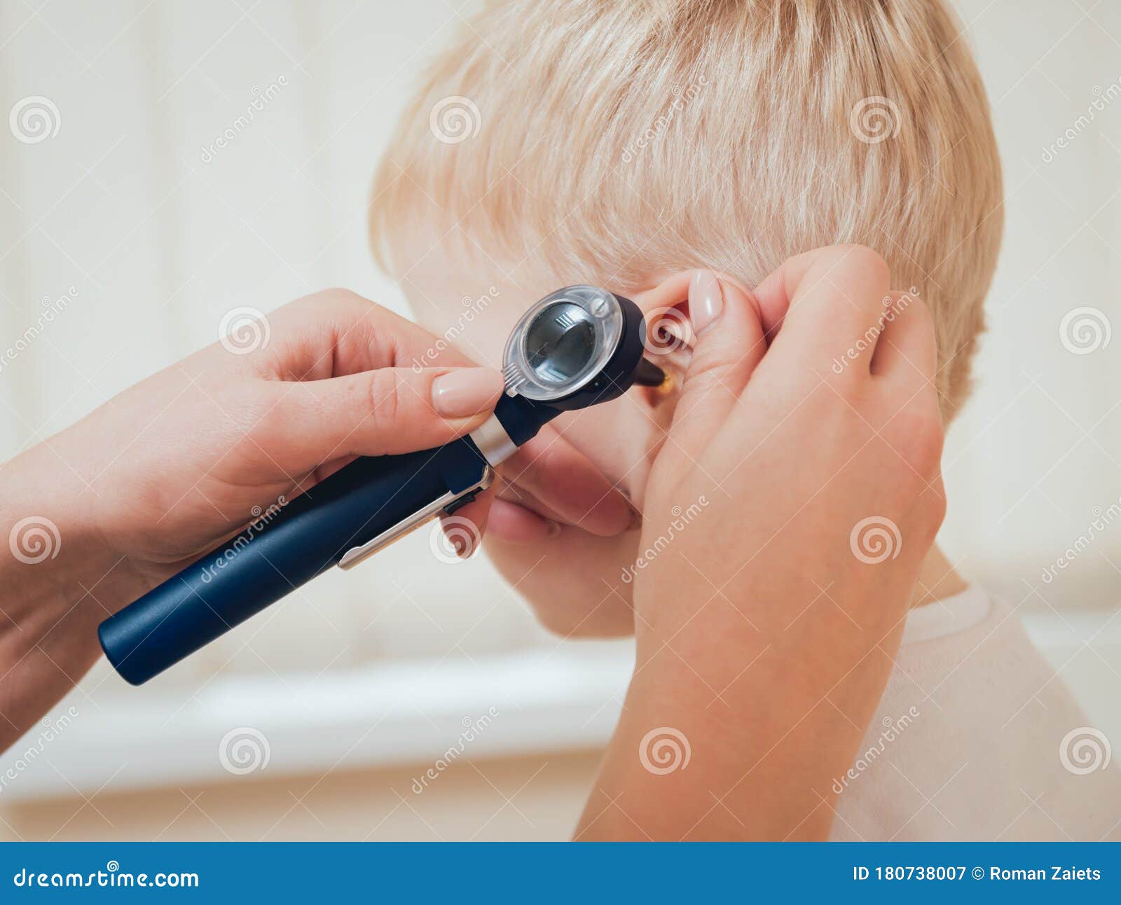 Doctor Examines Ear With Otoscope In A Pediatrician Room Stock Image
