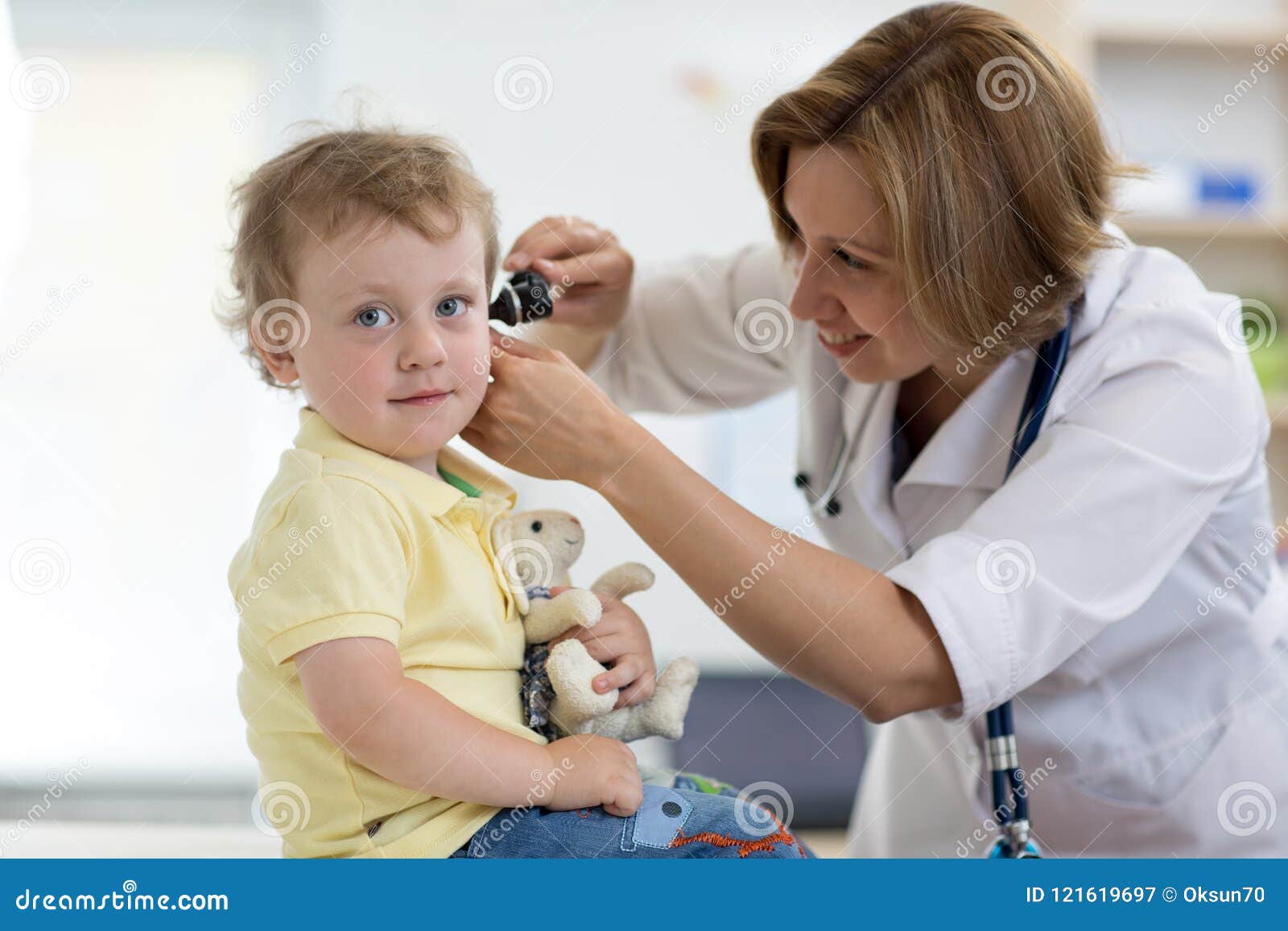 doctor examines ear with otoscope in a pediatrician room. medical equipment