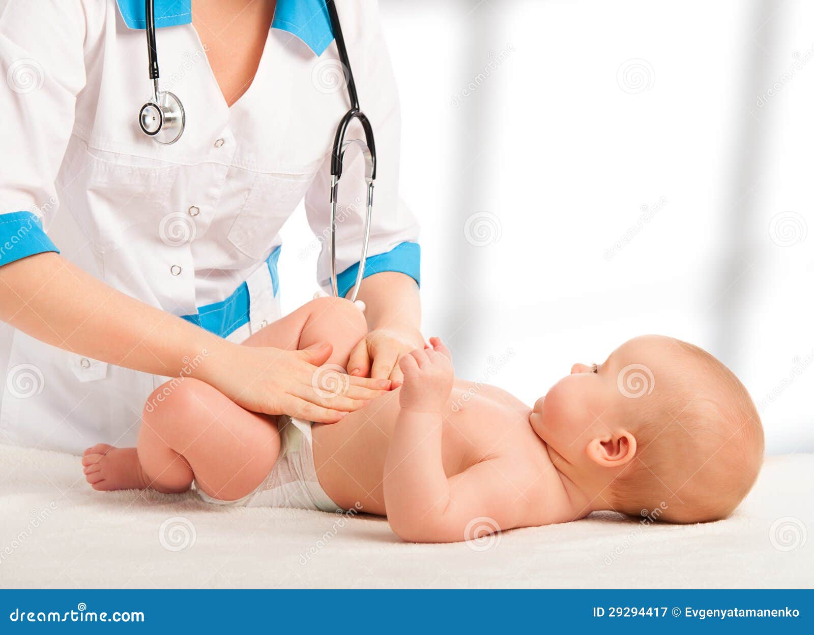 doctor examines, massaging baby tummy