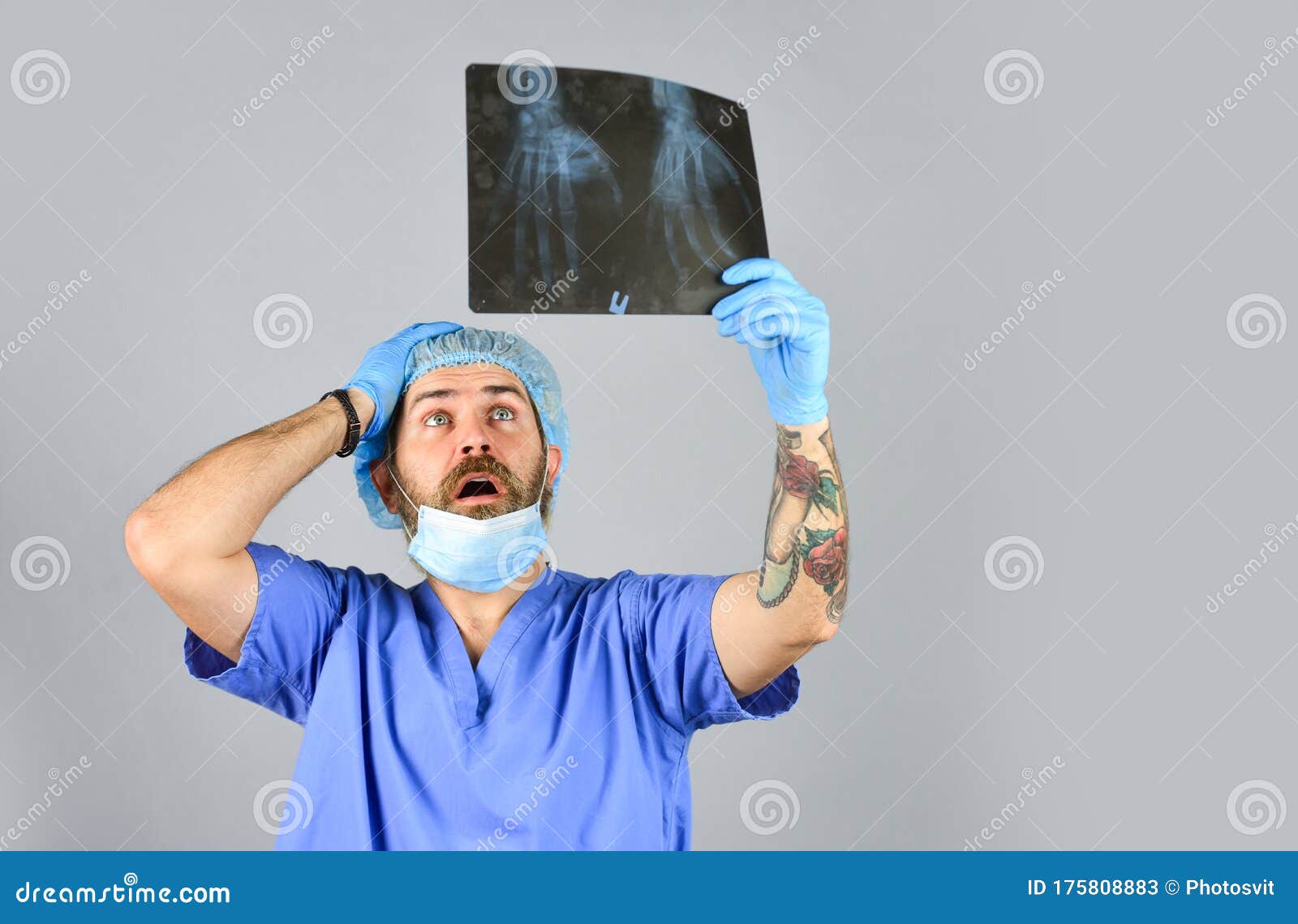 doctor examines radiographic snapshot of wrist. surgeon estimate damages. hospital emergency. doctor compares results. x