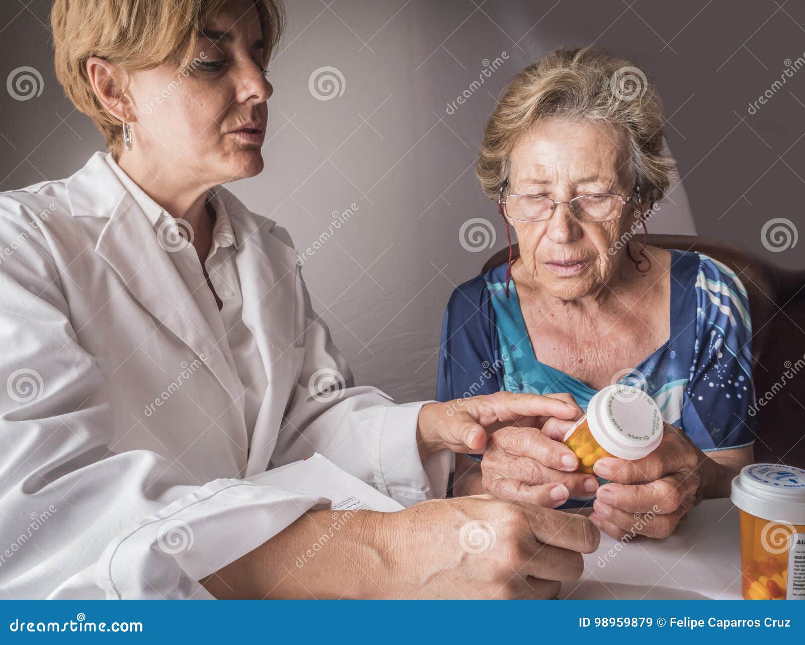 doctor explains to elderly daily dose of medication