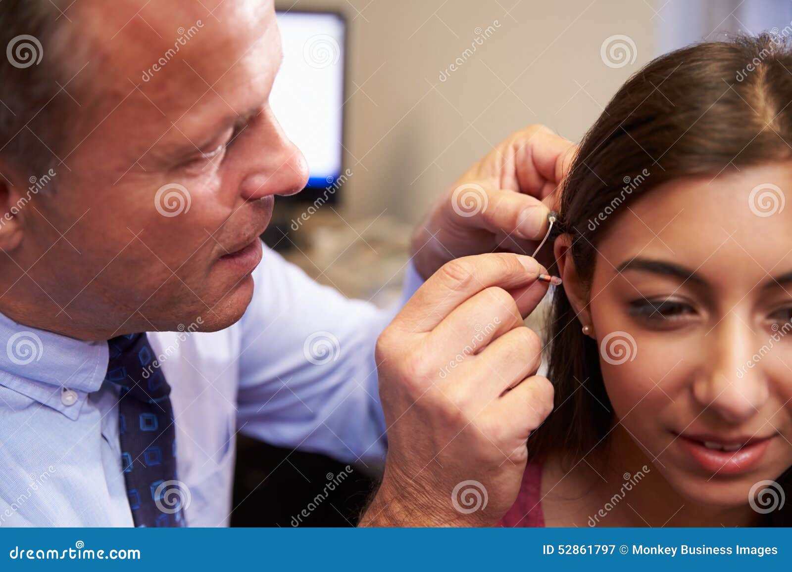Doctor Fitting Female Patient with Hearing Aid Stock Image Image of