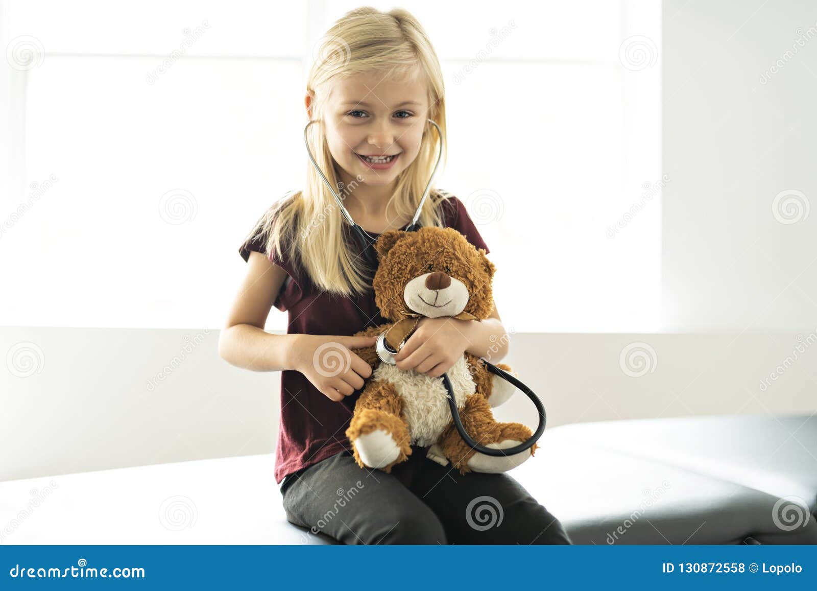 a doctor girl playing and cure bear at the pediatric