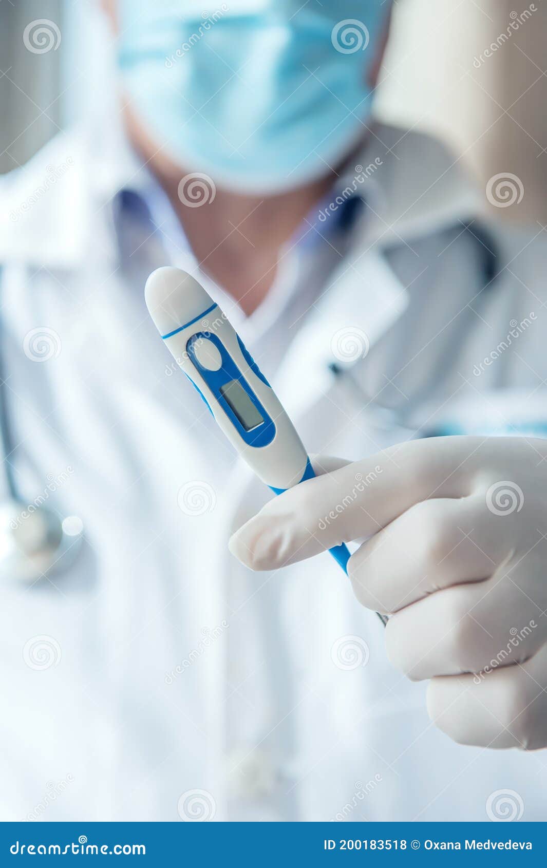 doctor gives a thermometer to measure the patient`s temperature. thermometry is important in the diagnosis of coronavirus