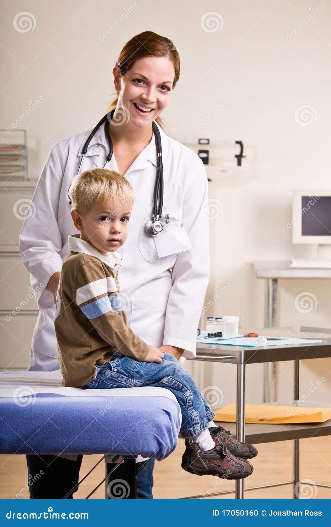 doctor giving boy checkup in doctor office