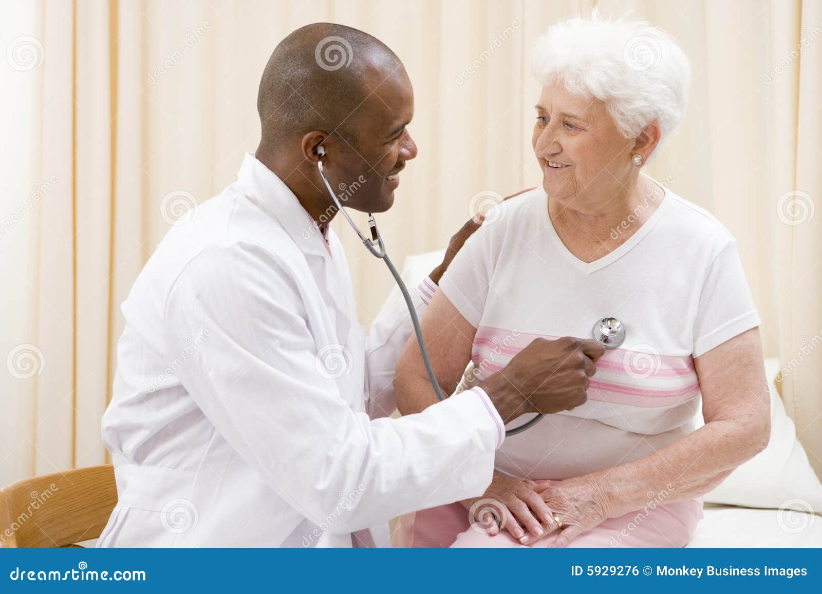 doctor giving checkup with stethoscope to woman
