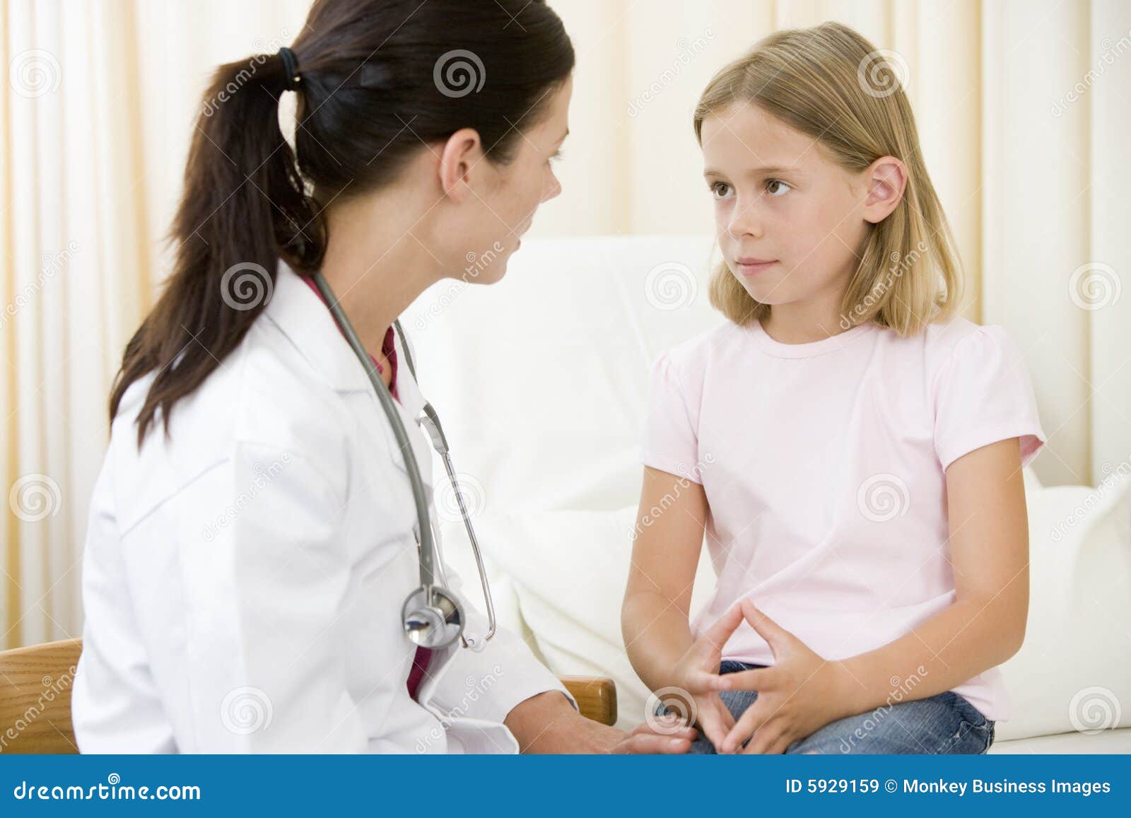 doctor giving checkup to young girl