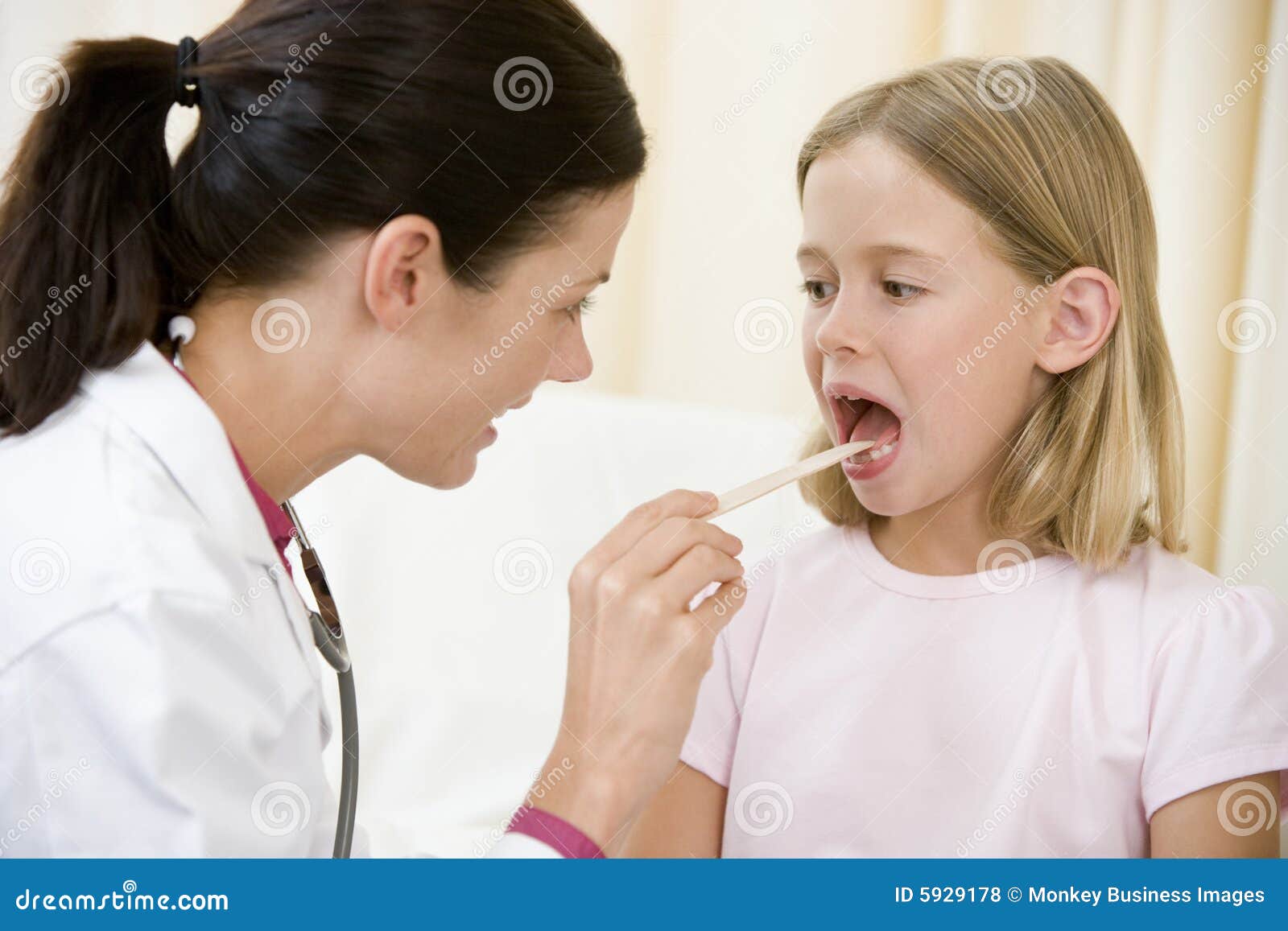doctor giving checkup to young girl