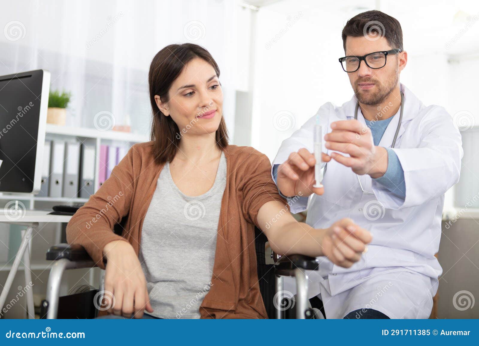 doctor giving female patient injection against virus