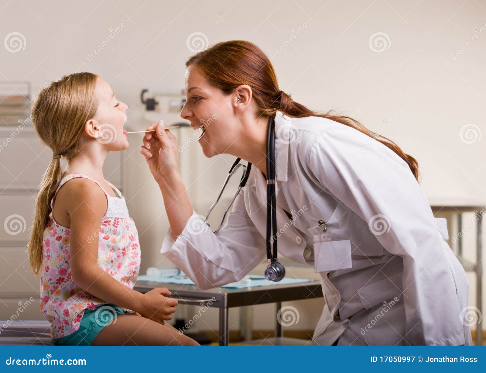 doctor giving girl checkup in doctor office