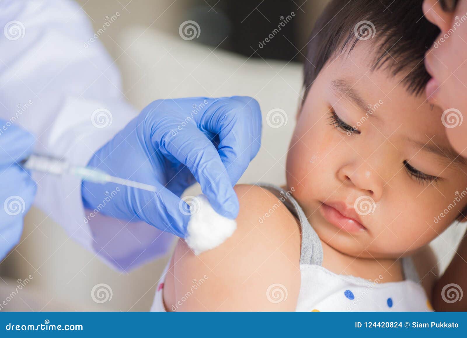 doctor giving an injection vaccine to a girl.