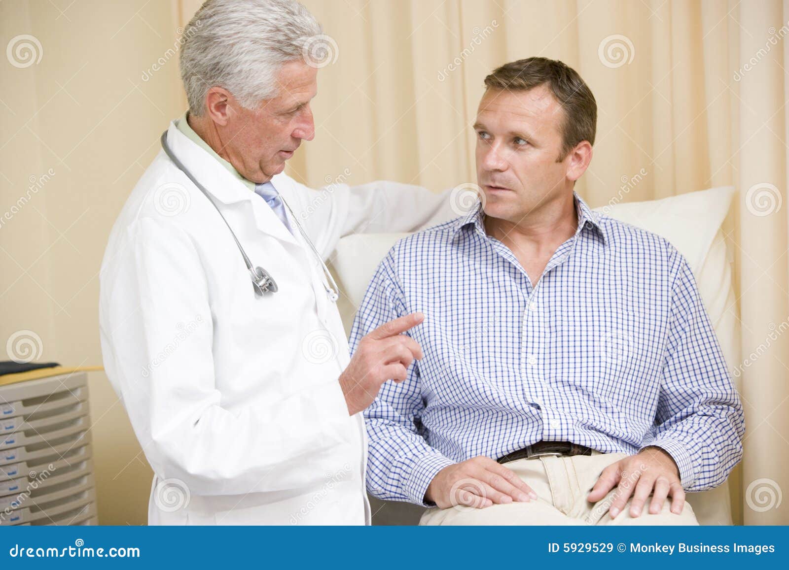 doctor giving man checkup in exam room