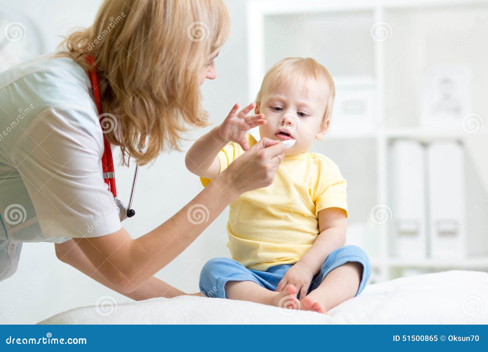 doctor giving medicament with a spoon