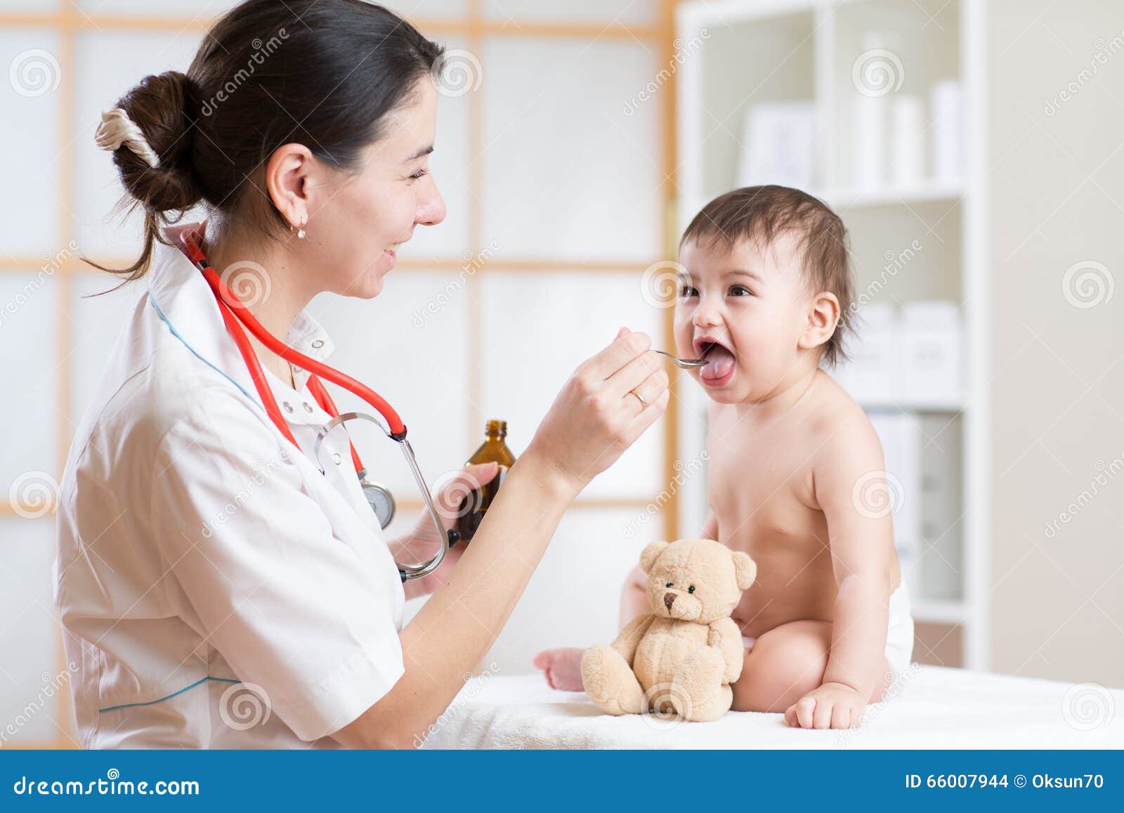 doctor giving medicament with a spoon