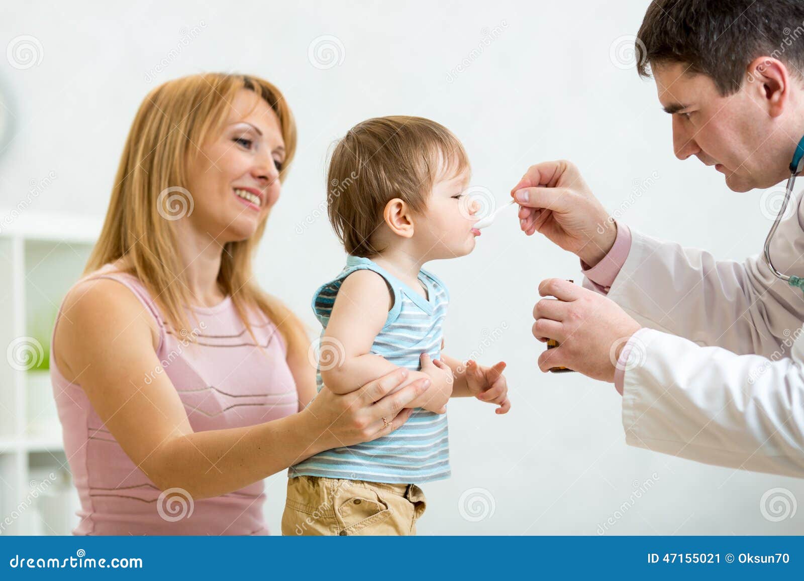 doctor giving medicament with a spoon