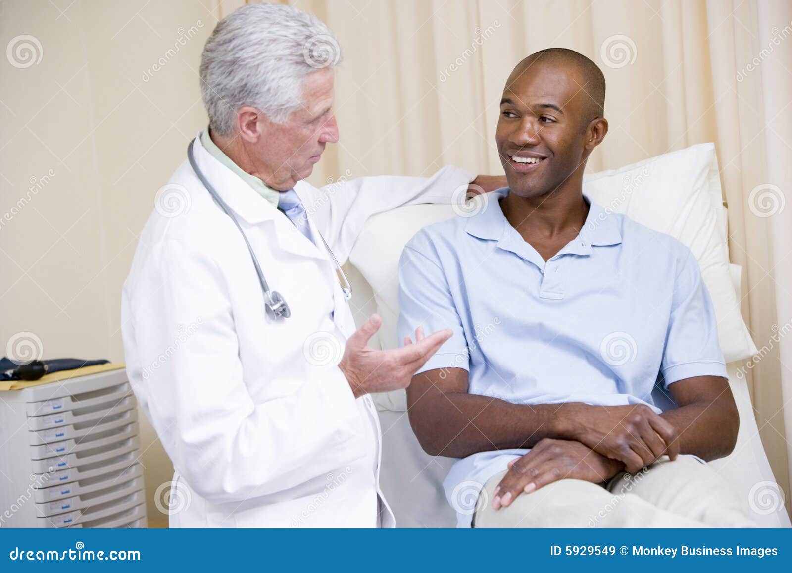 doctor giving smiling man checkup