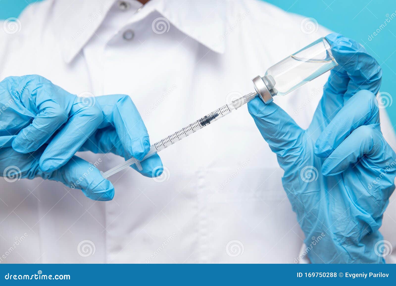 Doctor Hand Holding Syringe And Vaccine In Blue Gloves White Coat