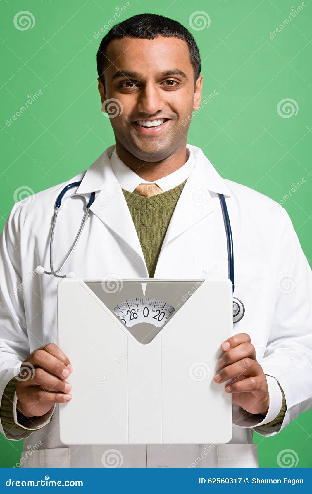 Doctor Holding Bathroom Scales Stock Image Image of ethnicity