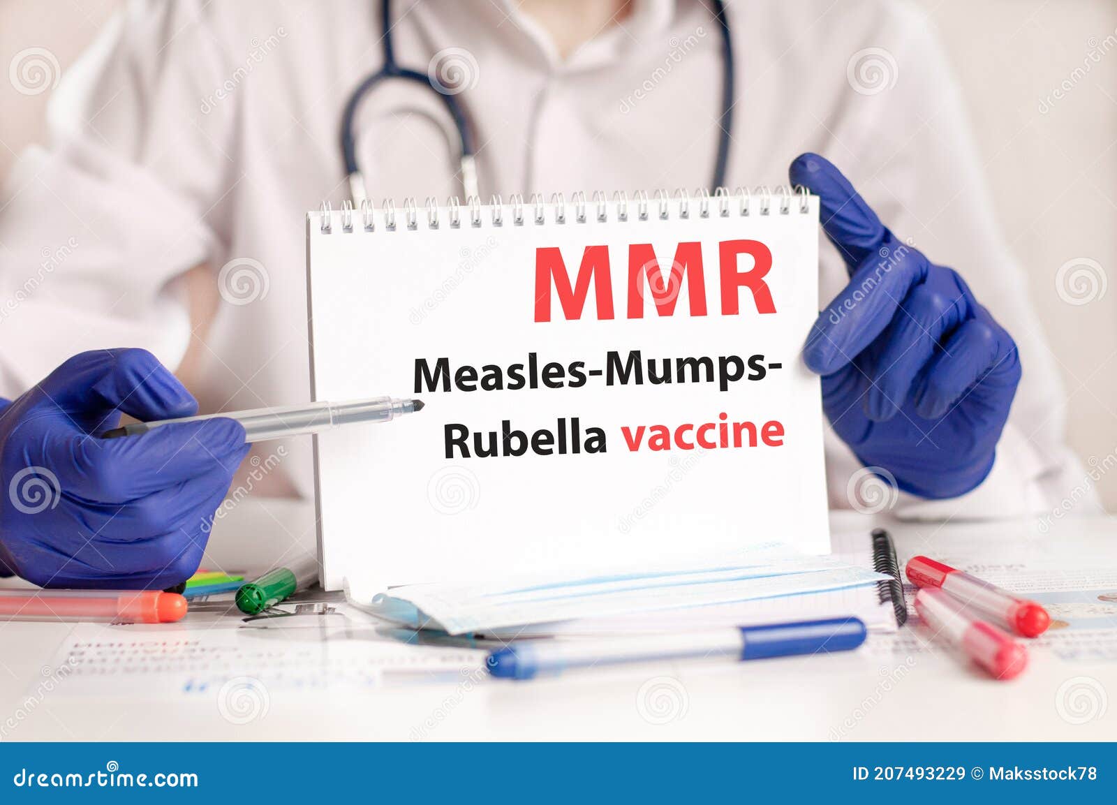 doctor holding a card with diagnosis words mmr - measles-mumps-rubella vaccine research. healthcare medical concept.
