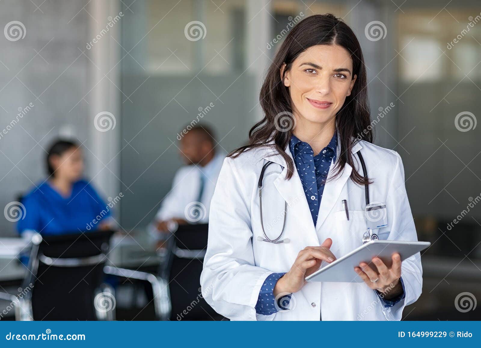 doctor holding digital tablet at meeting room