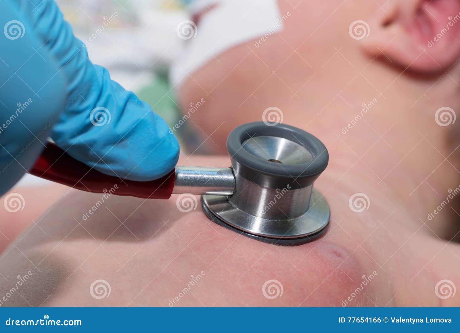 doctor holding stethoscope in his hand and doing auscultation newborn baby in neonata