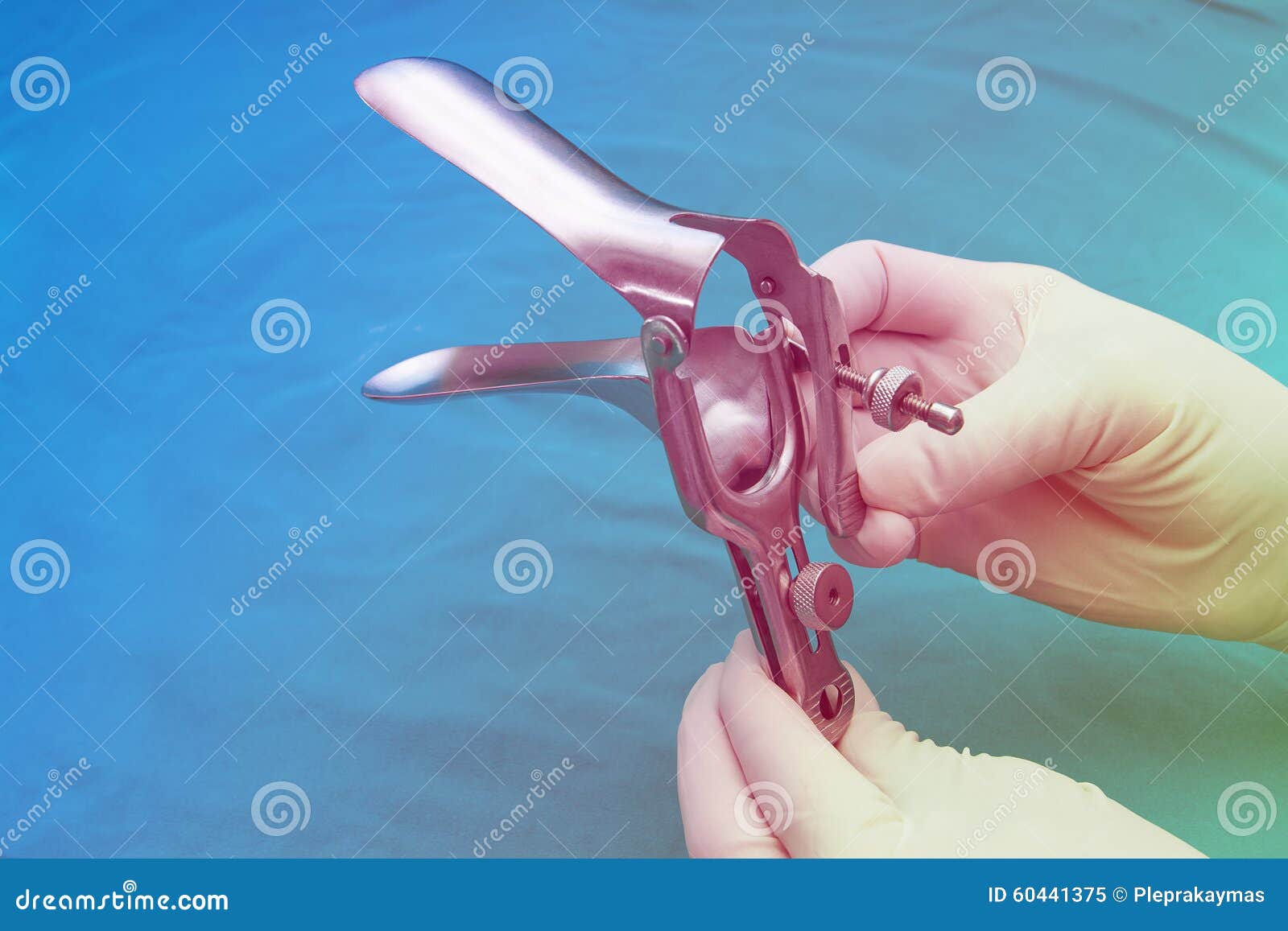doctor holds a disposable speculum