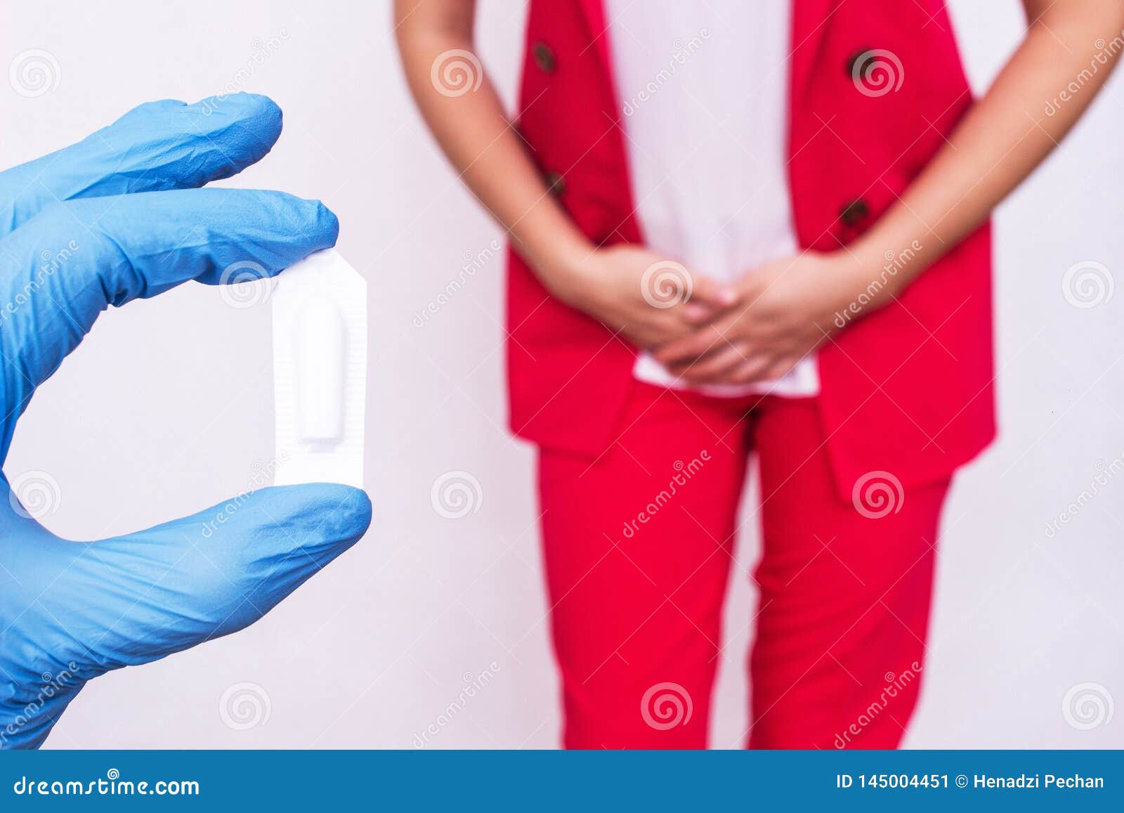 doctor holds vaginal suppository suppository against the background of a girl who has pain and inflammation, urological infections
