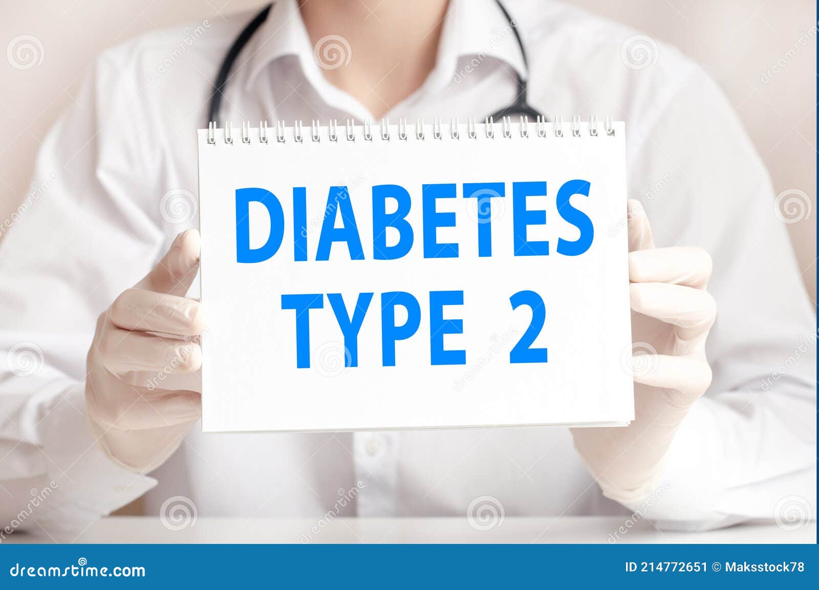 doctor holds a white sheet of paper and points to the text diabetes type 2, medical concept