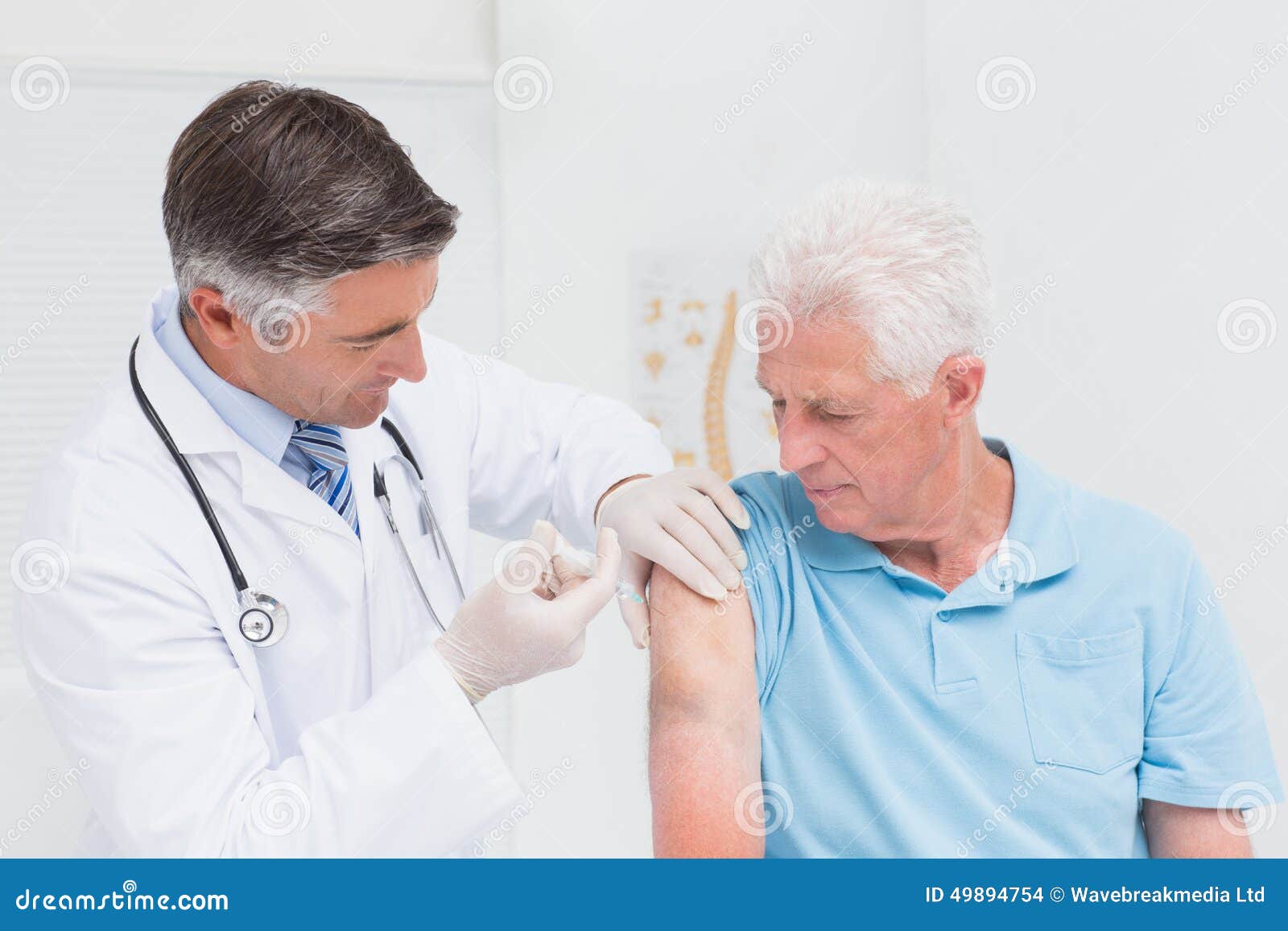 doctor injecting senior patient in clinic