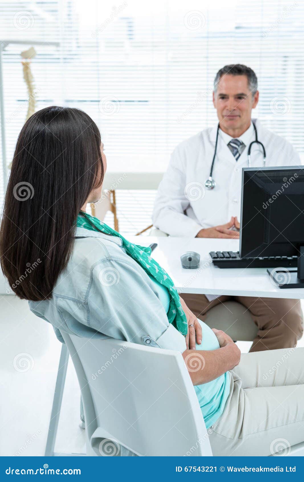 Doctor Interacting With A Pregnant Woman At Clinic Stock Image Image