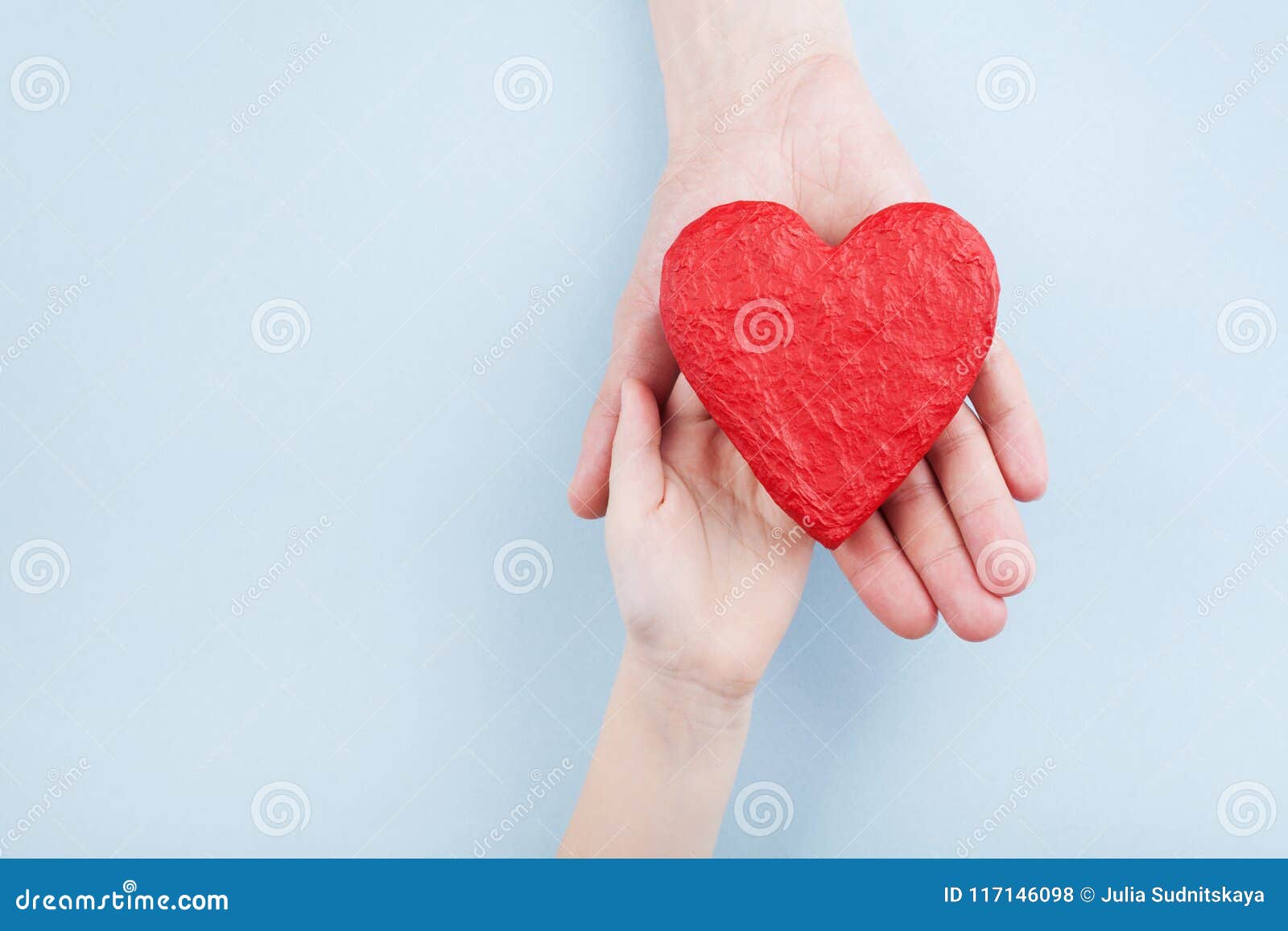 doctor and kid holding red heart in hands. family relationships, health care, pediatric cardiology concept.