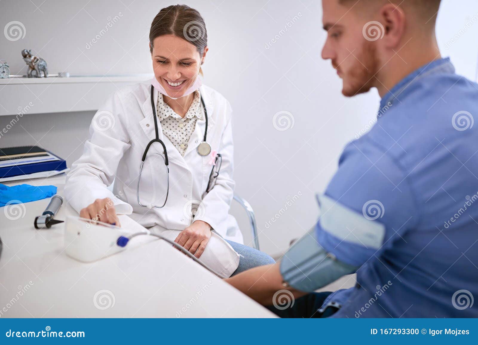 doctor measures blood pressure to patient