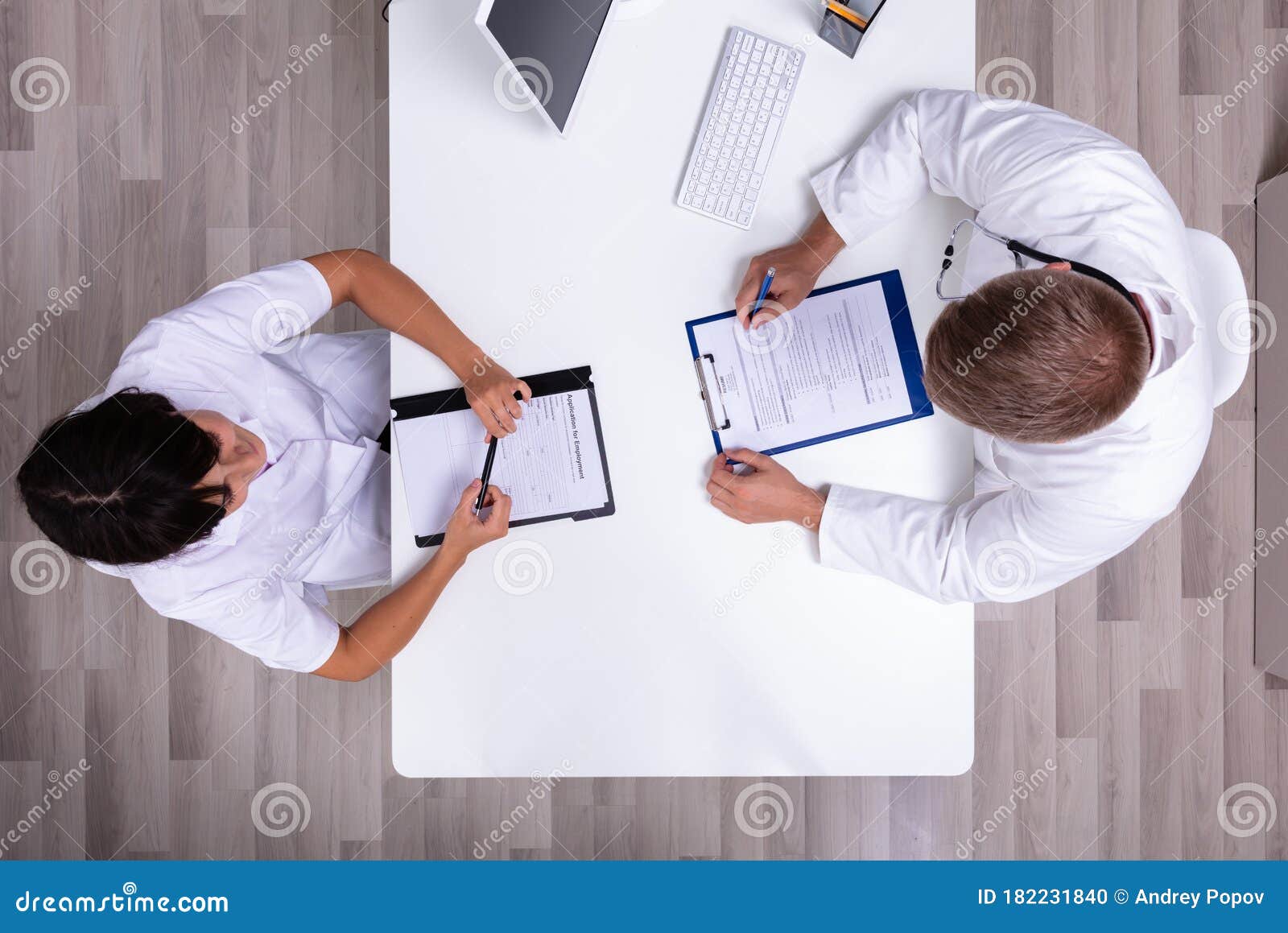 doctor and nurse sitting face to face having meeting