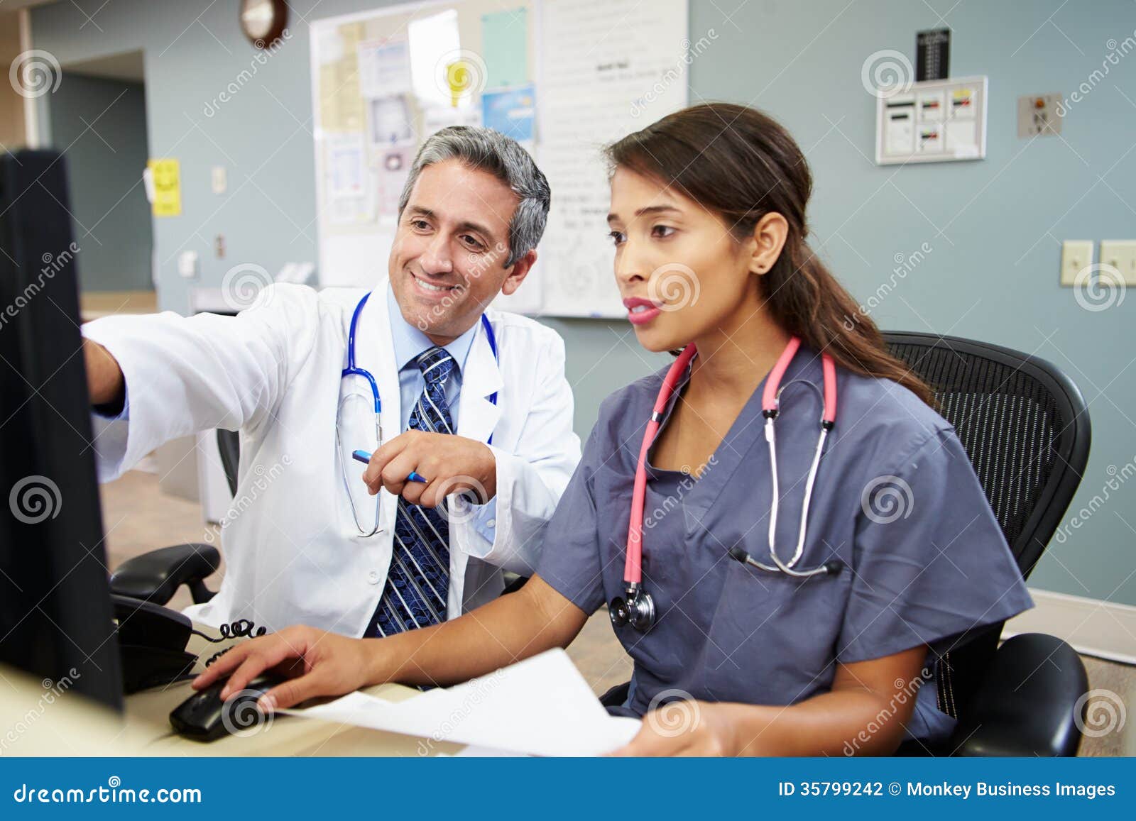 doctor with nurse working at nurses station